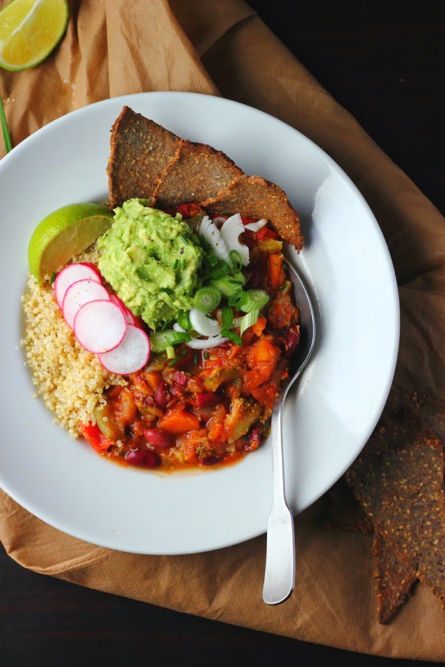 Spring chili with broccoli, zucchini and quinoa. Garnished with avocado, lime, radishes and spring onions. Vegan + gluten free.