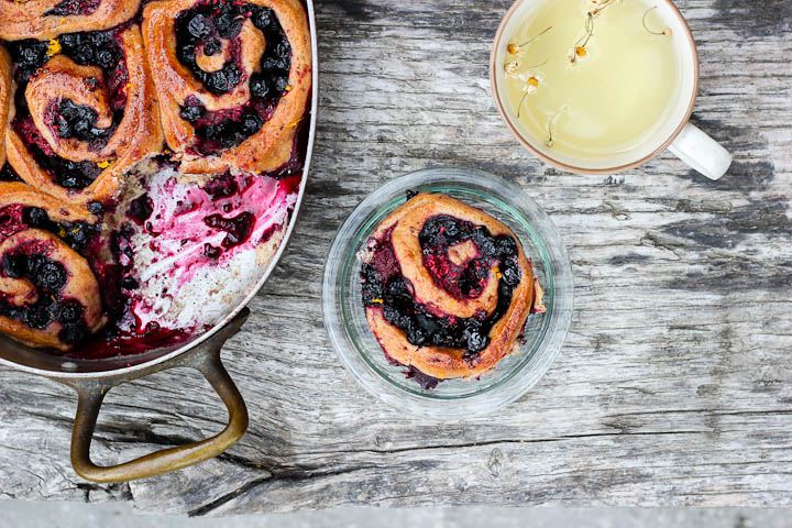 Vegan, whole grain and refined sugar free yeasted summer berry buns flavored with maple, orange and cardamom. Makes 10-15 buns.