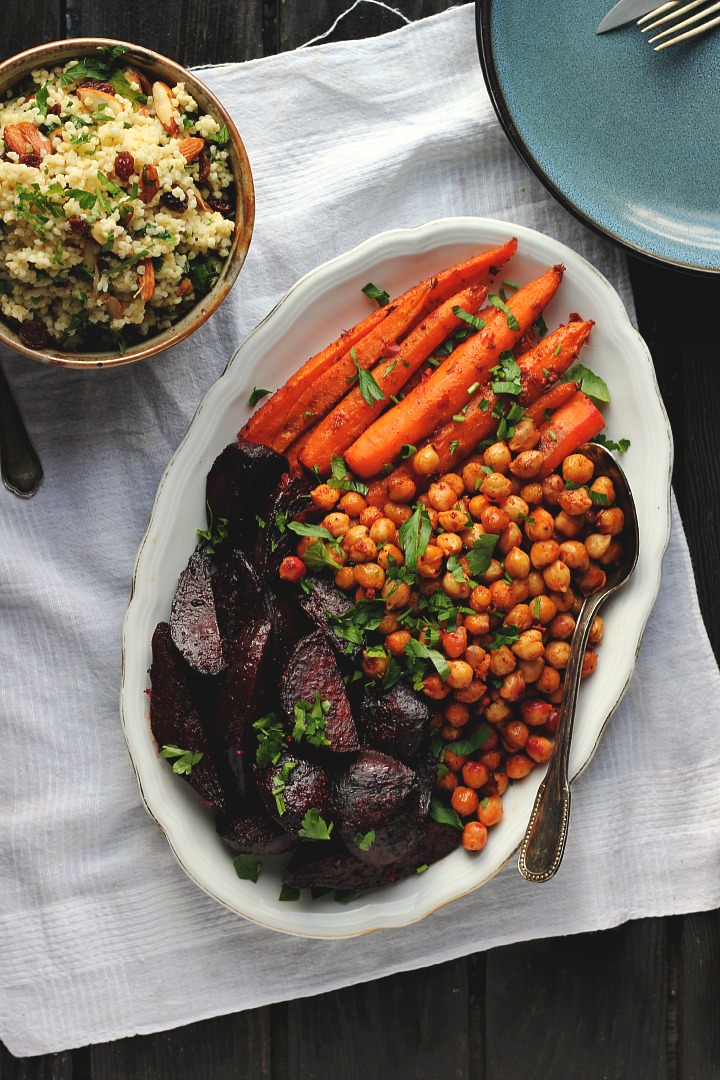 Harissa roasted carrots, beets + crispy chickpeas served with a herby millet pilaf with raisins, almonds and cilantro. Vegan + gluten free. Serves 4.
