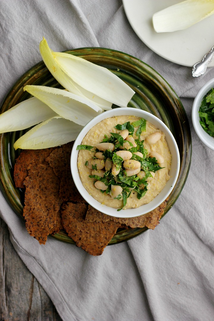 Creamy vegan white bean dip with roasted golden beets and shallots. Easy gluten free crackers made with flax seeds and brown rice flour.