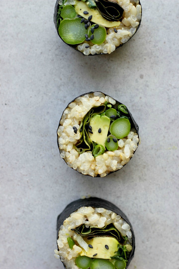 Spring brown rice sushi rolls with asparagus, sprouts, avocado, and a delicious creamy sesame ginger dipping sauce. Vegan + gluten free.