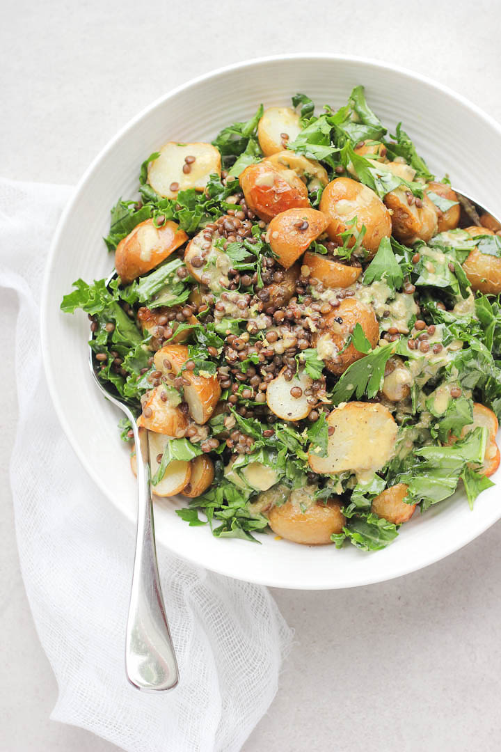 A crowd pleasing spring salad with a creamy lemon caper dressing. Packed with kale, beluga lentils and roasted new potatoes. Vegan + Gluten Free.