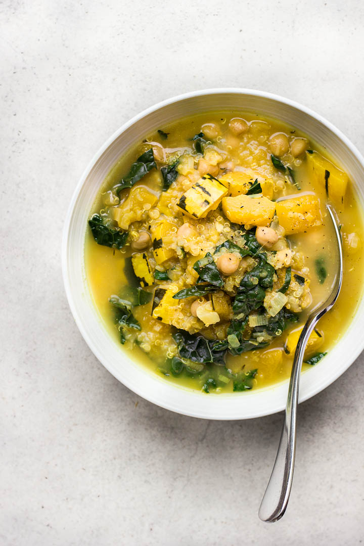 A warming vegan fall stew with a nutritional boost. Delicata squash stew with chickpeas quinoa, kale and an easy turmeric broth. Vegan and Gluten Free.