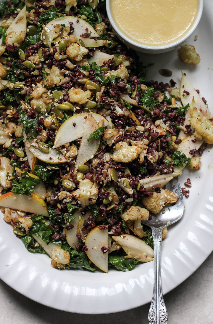 Roasted cauliflower salad with fragrant black rice, warm kale, crunchy seeds and a miso pear dressing. Vegan + Gluten free.