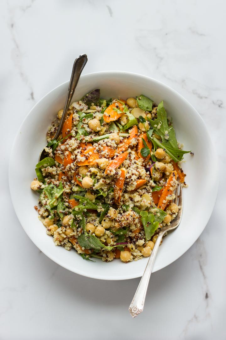 Roasted carrot salad with quinoa, chickpeas and almonds. Dressed in a creamy vegan everyday dressing loaded with tahini, dijon and nutritional yeast.