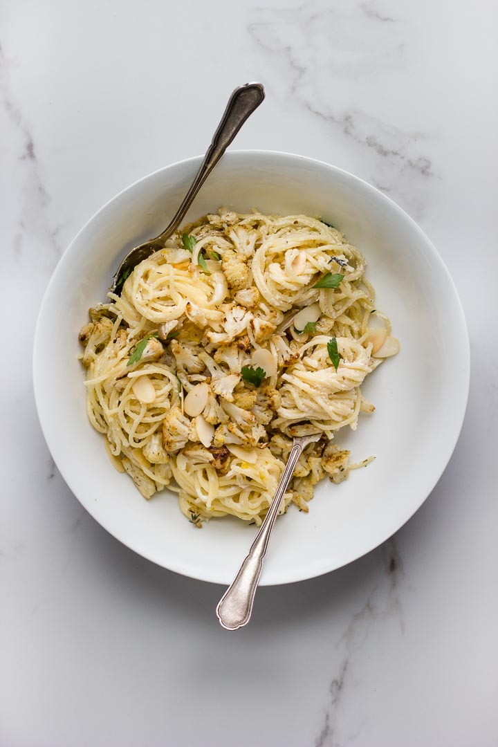 Roasted cauliflower pasta with lemon garlic ricotta, caramelized shallots + toasted almonds. Simple prep results in a stunning bowl of spaghetti.