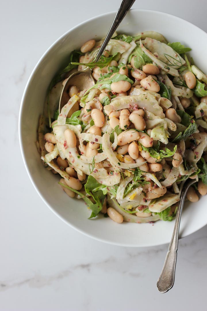 Shaved fennel white bean salad with an herby olive vinaigrette and lots of lemon. Vegan and gluten free. A simple and refreshing summer salad.