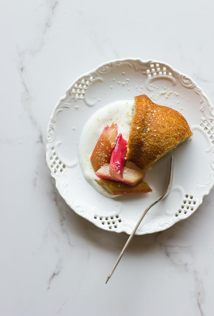 A simple vegan olive oil yogurt cake with maple syrup and vanilla. Topped with maple vanilla roasted rhubarb. A light and fresh spring dessert.