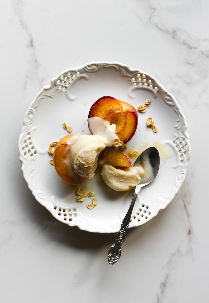Easy, creamy vegan oat milk ice cream made with oats, vanilla and honey. Served with grilled peaches and honey toasted oats. 
