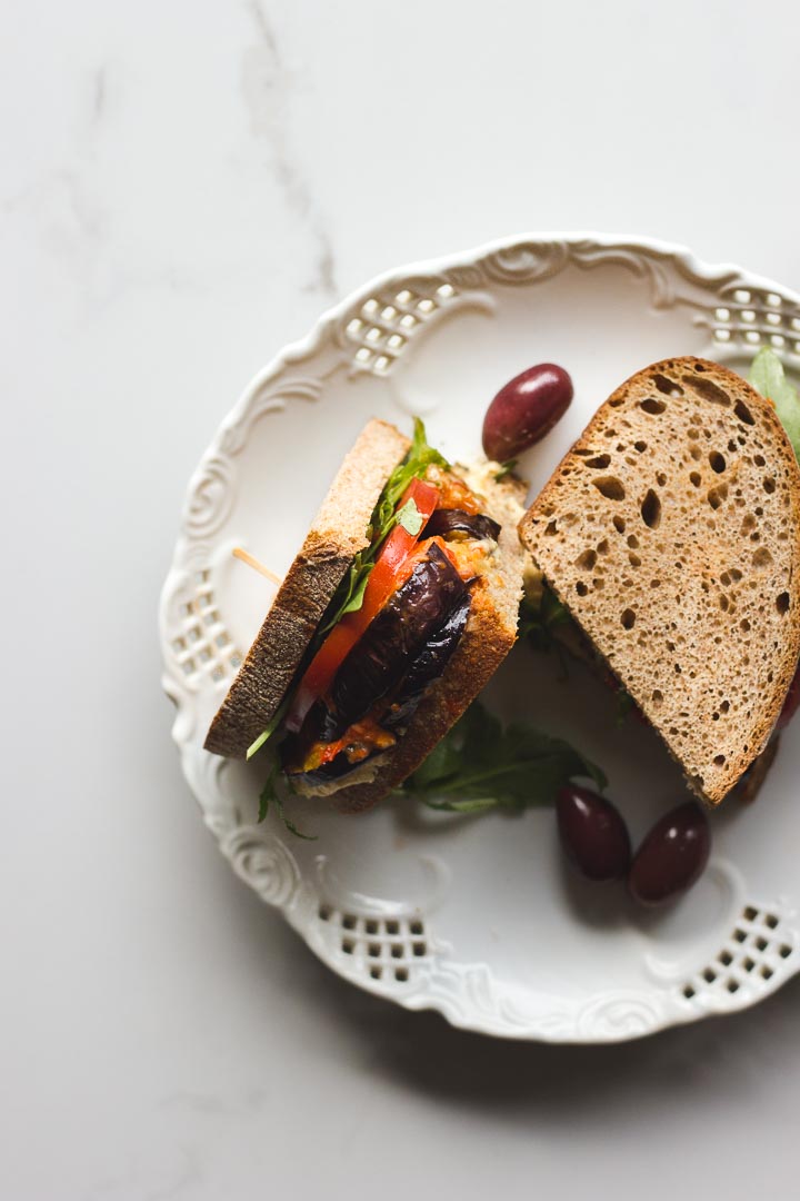 Vegan roasted eggplant sandwich with hummus and harissa relish. Made with Mina harissa. Simple, quick and easy for lunch or on the go.
